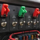 Toggle Switch Missile Cover Green installed and in use on dashboard switch panel