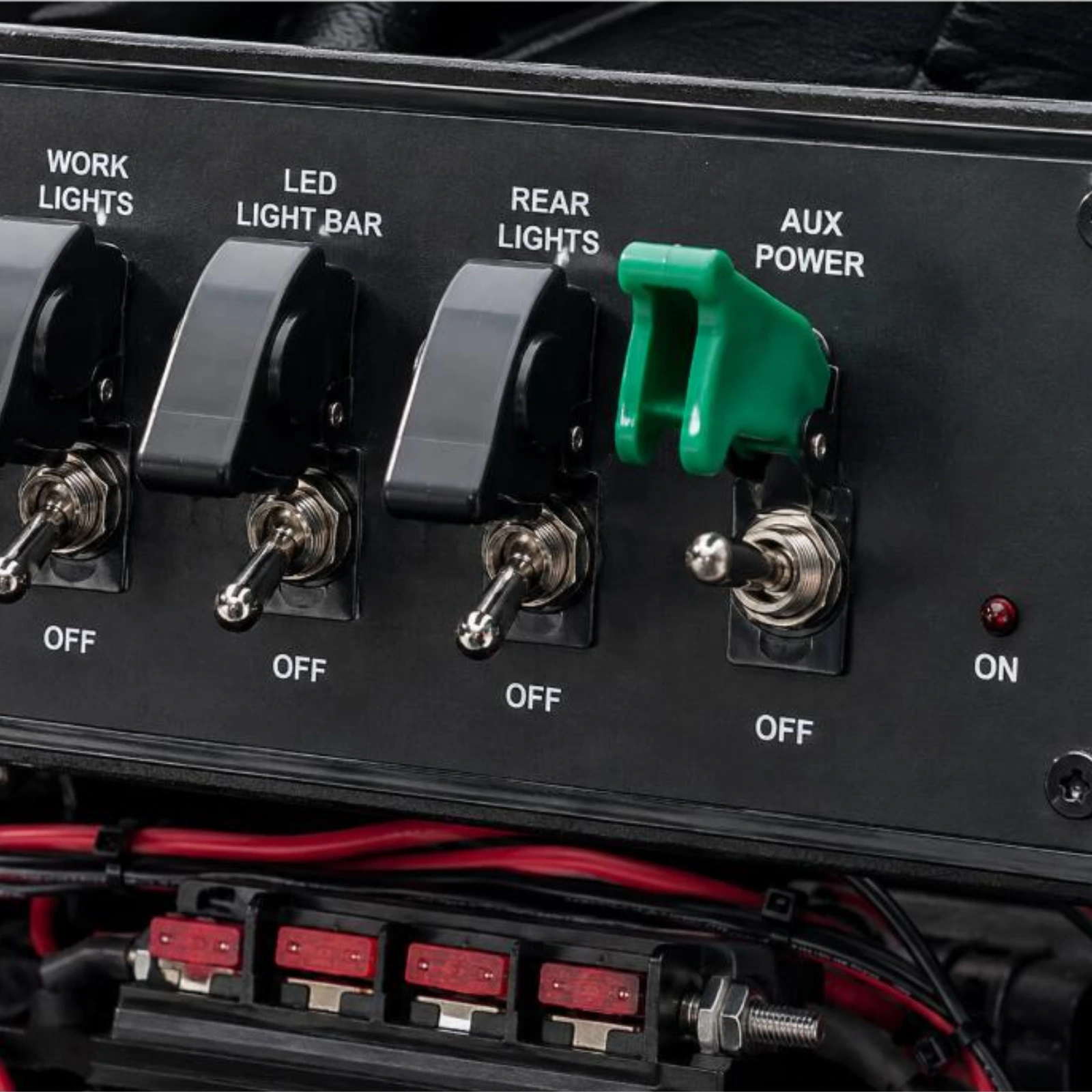 Toggle Switch Narva SPST 20A With Green Missile Switch Cover installed on dashboard panel