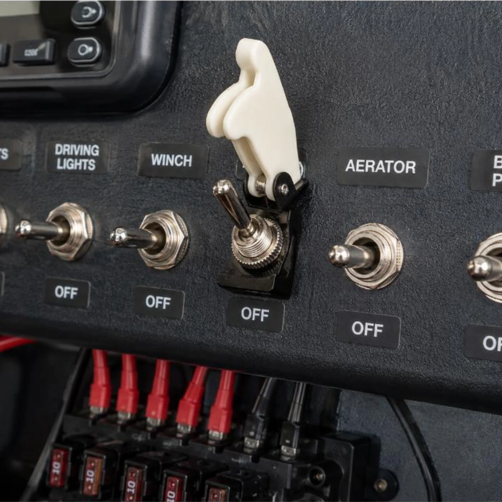 Toggle Switch Narva SPST 20A With White Missile Switch Cover installed on dashboard panel