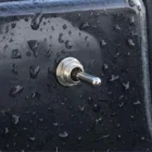 Cole Hersee 55021-07BX toggle switch installed on boat panel with water