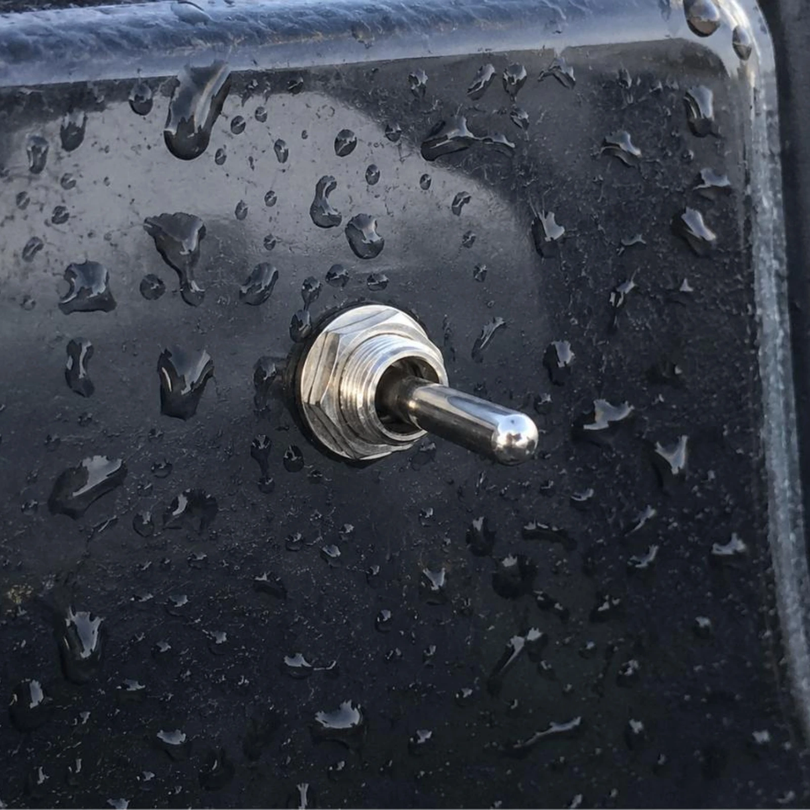 Cole Hersee 55021-07BX toggle switch installed on boat panel with water