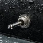 Cole Hersee 5582-10BX toggle switch installed on boat panel with water