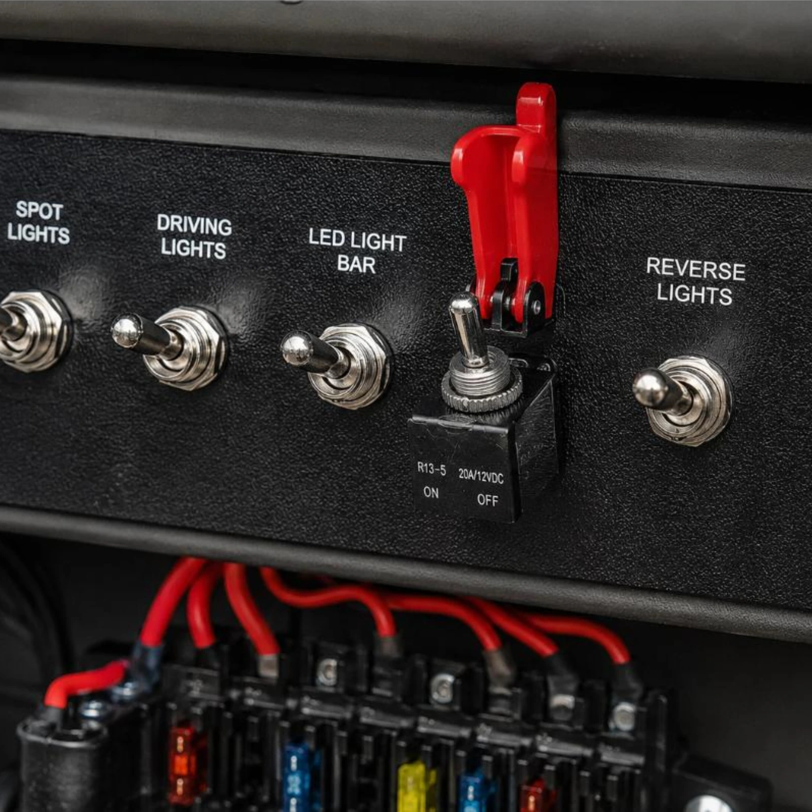 Narva SPST toggle switch with red missile switch cover installed on vehicle dashboard panel