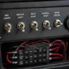Toggle Switch TS-030 installed flush in boat dashboard panel wired to fuse holder