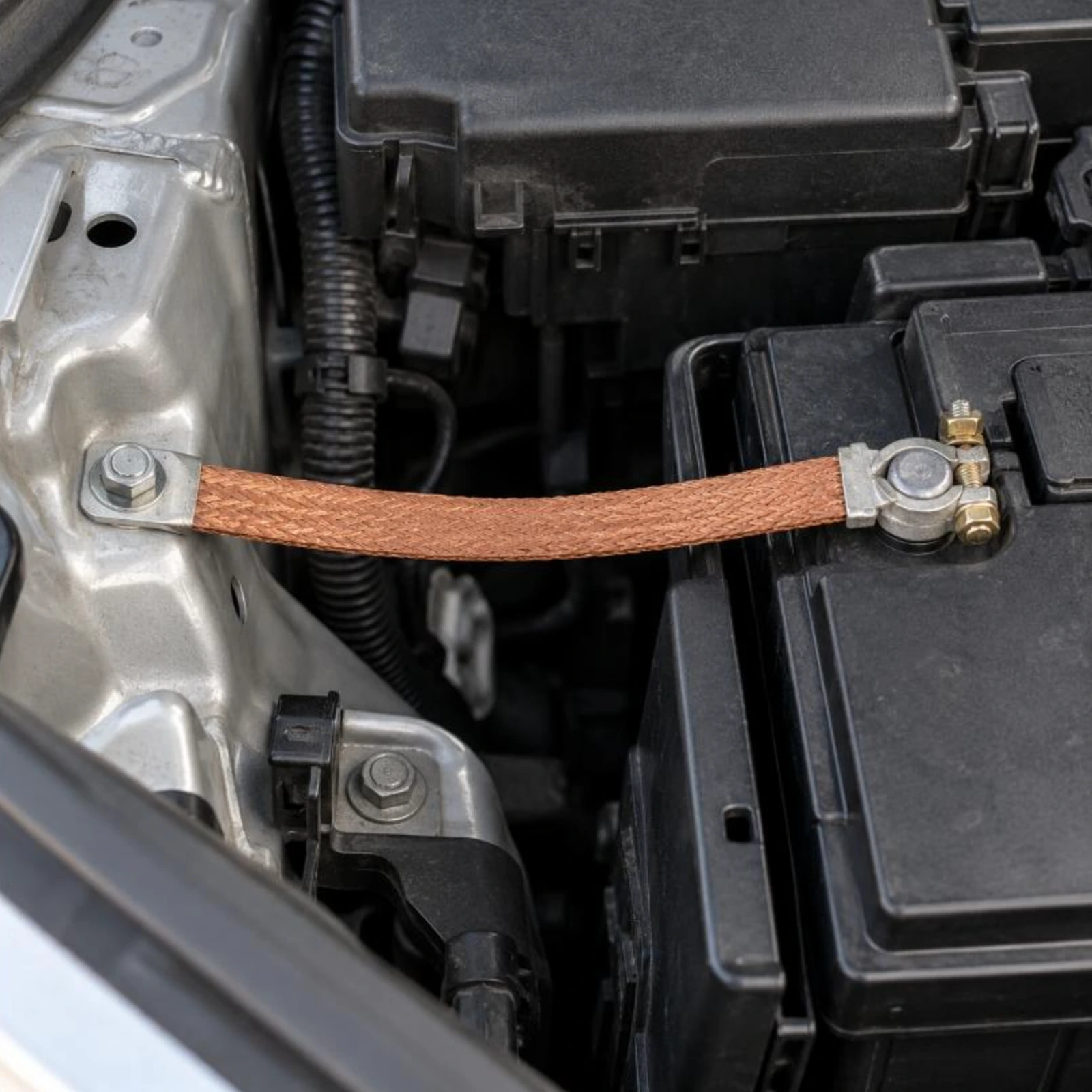 Braided copper battery earth strap fitted from the battery negative post to the vehicle body