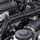 Black nylon cable ties bundling and securing a wiring loom in a 4WD engine bay