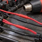 Red and black single wall heat shrink insulating wire joins with a heat gun